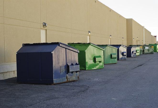 a group of construction workers taking a break near a dumpster in Cordell